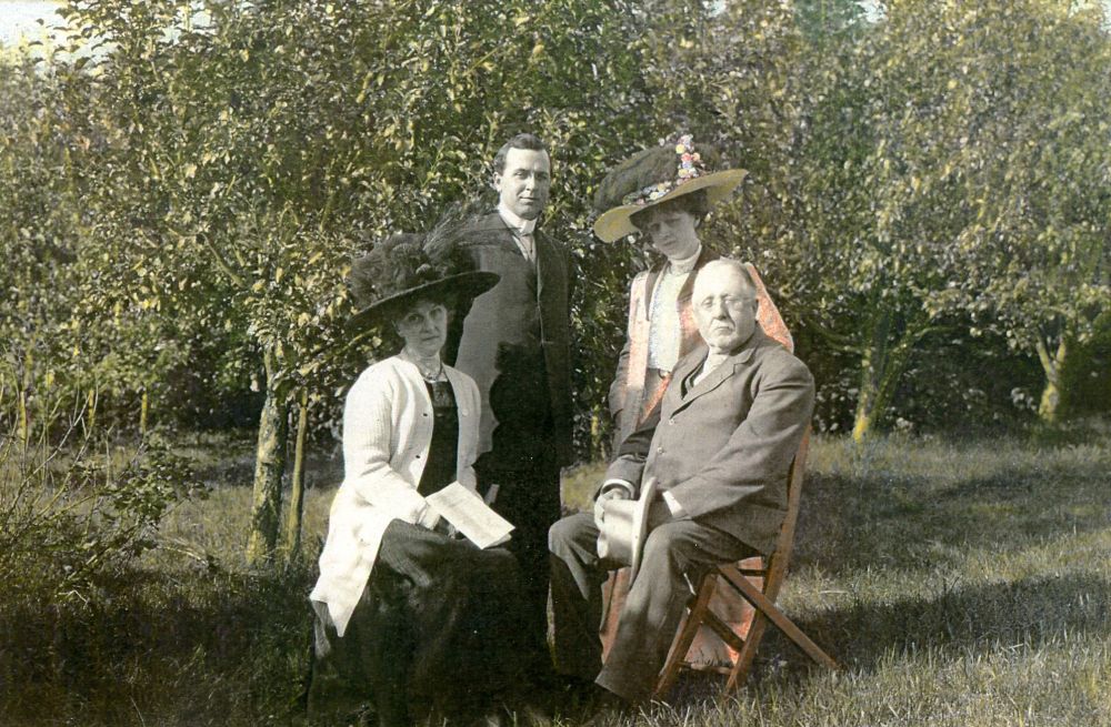Family photo (father, mother, son and daughter) in front of trees