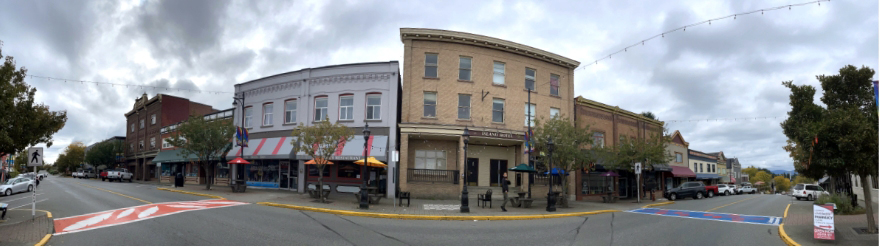 Panoramic photograph of early 20th century commercial buildings lining First Avenue in Ladysmith.