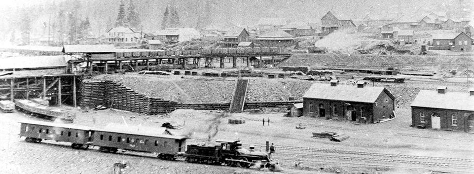 Black and white panoramic photo of multilevel coal loading railway facilities.