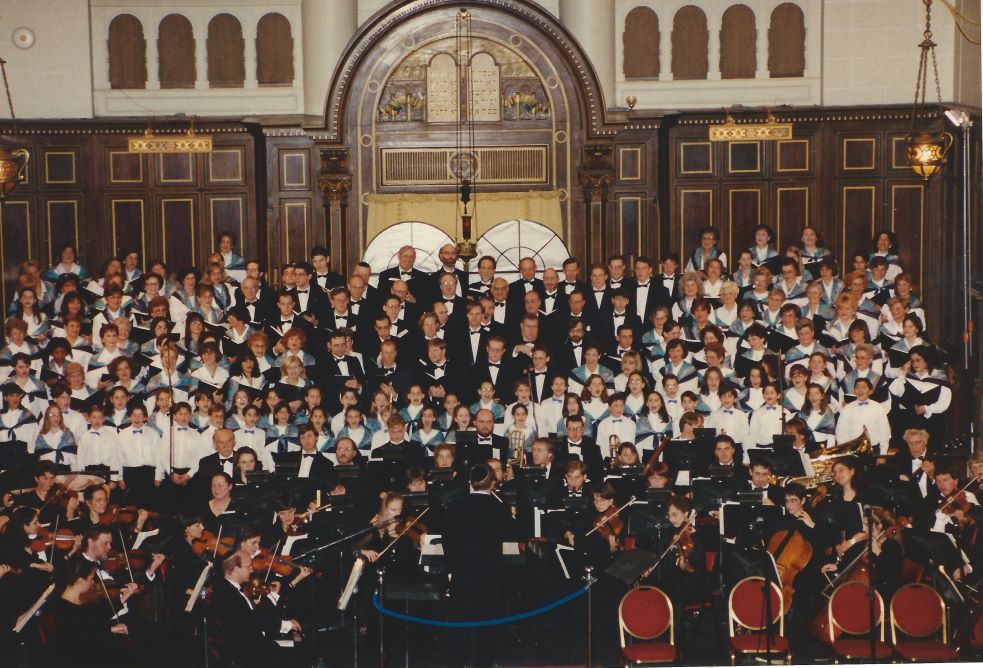 A large group of people performing in a concert at a synagogue.