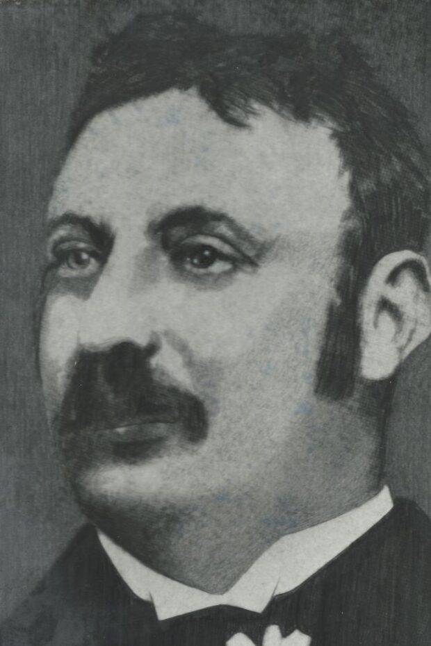 A late 19th century black-and-white detailed sketch of a man with a short moustache wearing a suit, John E. Moss.