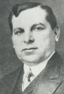 An early 20th century black-and-white head-shot of man in a suit, Lyon Cohen.