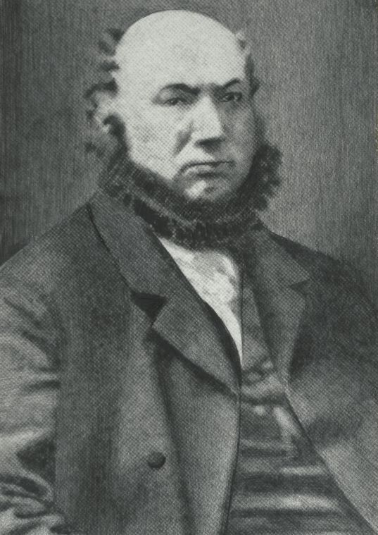 A 19th century man with a chinstrap beard, and wearing a suit. Marcus Ollendorf