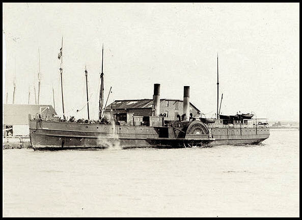 Sepia photograph of a two-funnel paddle steamer moored at a wharf. The medium size steamer has two funnels. On the rear deck is stored the lifeboats; some passengers are present on the front deck.