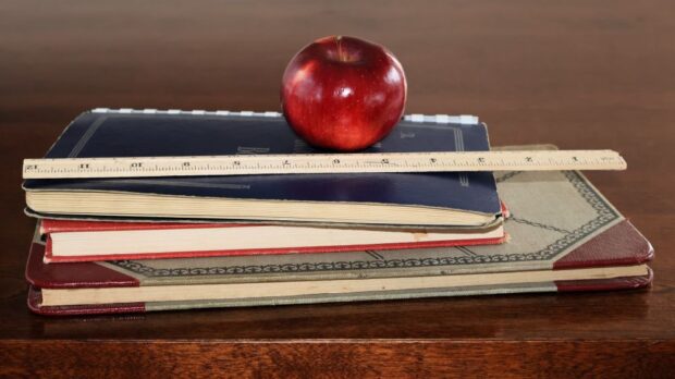 A stack of books with an apple on top
