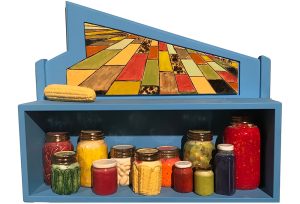 Blue shelf with jars of vegetables and an image of a field