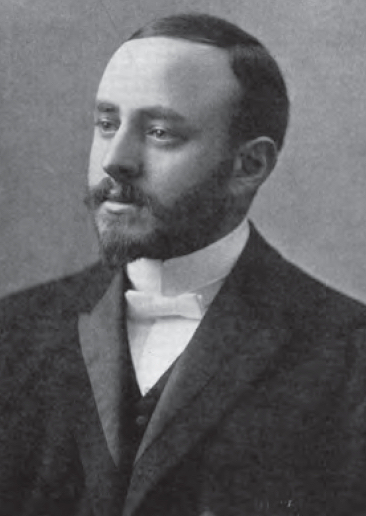 A black-and-white early 20th century photograph of a man with a short-trimmed beard, wearing a suit. Rabbi Herman Abramowitz.