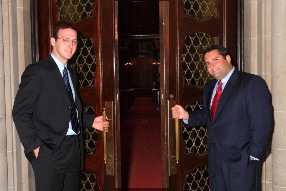 Rabbi Adam Scheier & Gideon Zelermyer pose outside the doors to the main sanctuary of the Shaar Hashomayim.