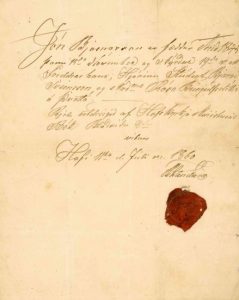 A historical handwritten document on aged, yellowed paper with elegant cursive script in dark ink. The text is written diagonally across the upper half of the page. In the lower right section, there is a red wax seal partially pressed onto the paper, suggesting it is an official or legal document. The page is otherwise blank, with slight creases and faint stains from age.