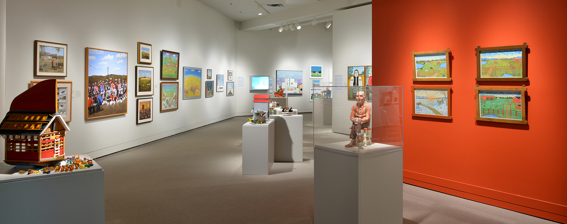 View of an art gallery space full of several artworks