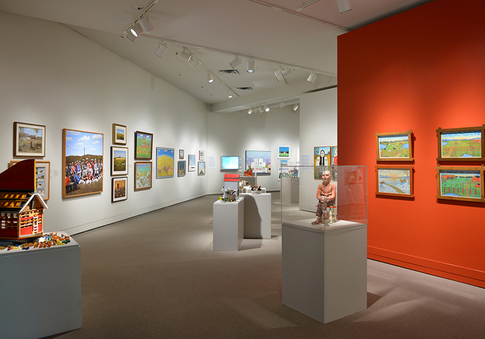 View of an art gallery space full of several artworks