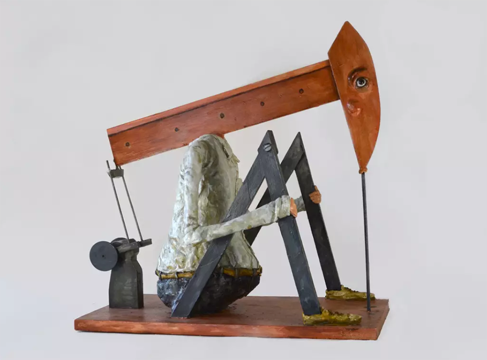 Sculpture of a human body combined with a pump jack